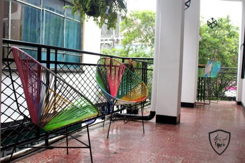 a group of chairs sitting on a balcony at Hotel El Barcino in Neiva