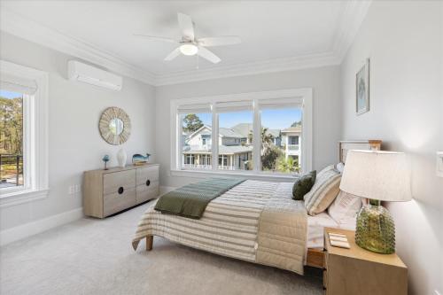 a white bedroom with a bed and a window at 8 Sea Front, Oceanfront Estate, Pool, Game Room, Elevator in Hilton Head Island