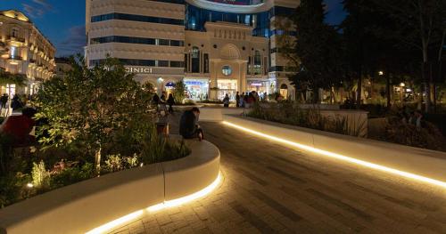 a street in a city at night with lights at Square Boutique Hotel in Baku