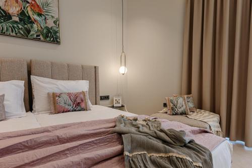 a bedroom with two beds with pillows at 1864 Apartments in Zakynthos