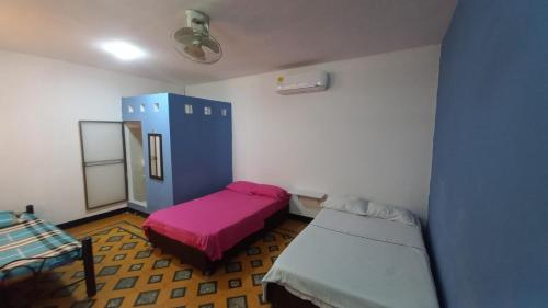 a small room with a bed and a couch at Hotel El Barcino in Neiva
