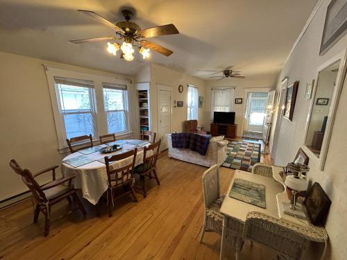 a dining room and living room with a table and chairs at Cottage near beach and boards! in Ocean City