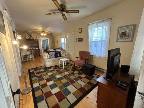 a living room with a couch and a tv at Cottage near beach and boards! in Ocean City