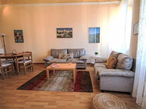 a living room with a couch and a table at Apartment Roma by Interhome in Porto Valtravaglia