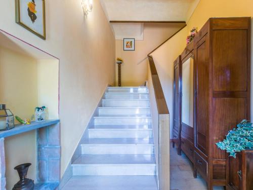a staircase in a house with a stair case at Apartment L'Uccelliera-3 by Interhome in Canneto