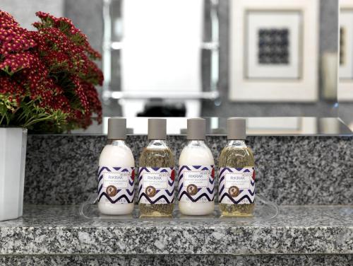 four bottles of olive oil and eggs on a counter at The Soho Hotel, Firmdale Hotels in London