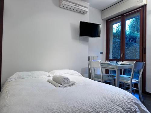 a bedroom with a bed and a table and a window at Angolo romantico in Bergamo