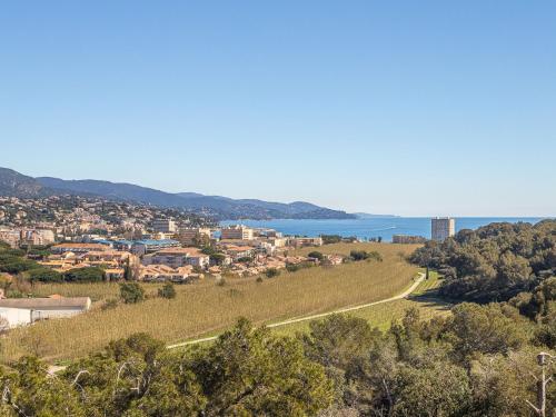une ville sur une colline avec l'océan en arrière-plan dans l'établissement Apartment Le Bois du Coteau by Interhome, à Bormes-les-Mimosas