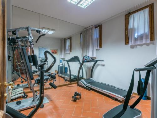 a gym with several tread machines in a room at Holiday Home Villa Silvana by Interhome in Marcialla