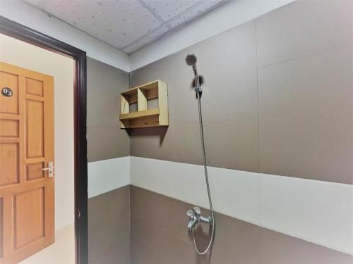 a shower in a room with a shower head at Ha Linh Home-My Khe Beach-Kitchen-High speed Wifi in Da Nang