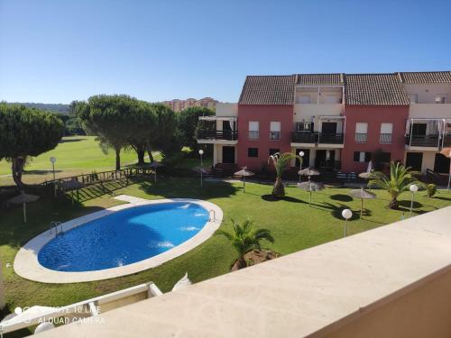 a view of an apartment complex with a swimming pool at Comfortable penthouse in Islantilla golf in Lepe