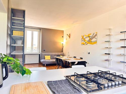 a kitchen and living room with a stove and a table at Vista sui colli di Bergamo in Bergamo