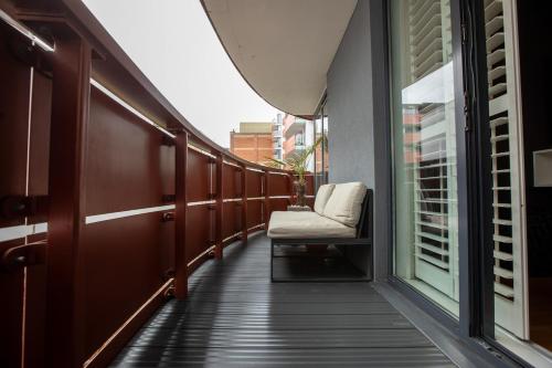 a balcony with a chair and a window at Luxury London Apartment in London