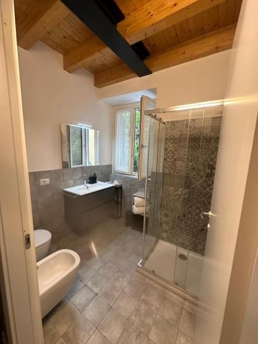 a bathroom with a shower and a toilet and a sink at In CITY CENTER with PATIO in Como