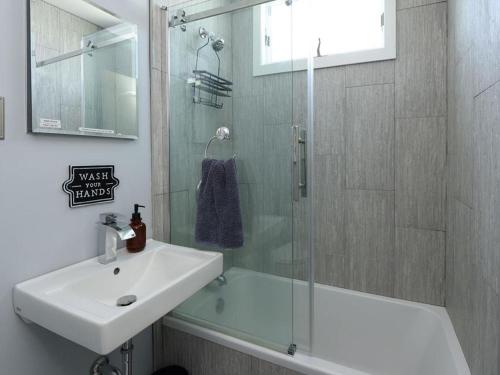 a bathroom with a sink and a glass shower at Beach Haven West Has It All, Pool, Hot Tub in Beach Haven West