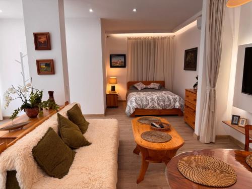 a living room with a couch and a bed at Mieszkanie bez barier, przytulność na każdym kroku in Myślenice