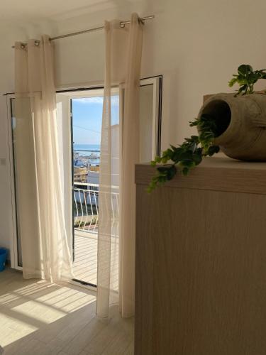 a room with a sliding glass door to a balcony at La Casa di Sara in Porto Empedocle