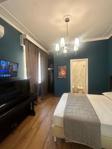 a bedroom with a large bed and a piano at Sunset Guest House in Reggio Calabria
