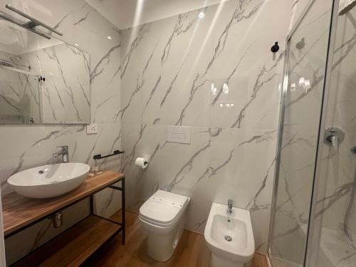 a bathroom with a sink and a toilet and a shower at Sunset Guest House in Reggio Calabria