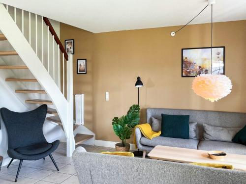 a living room with a couch and a staircase at 8 person holiday home in Gjern in Gjern