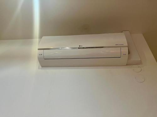 a white printer sitting on top of a counter at Riverbridge Apartments Prague in Prague