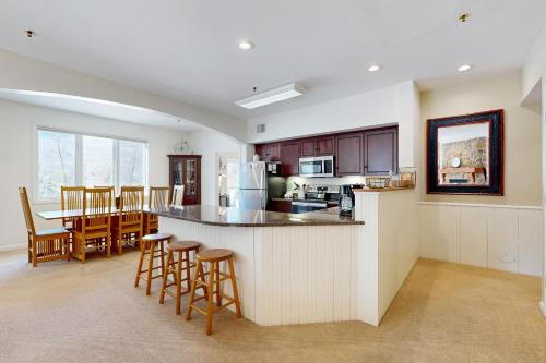 a kitchen and living room with a counter and chairs at Eagles Unit #1 in Jeffersonville