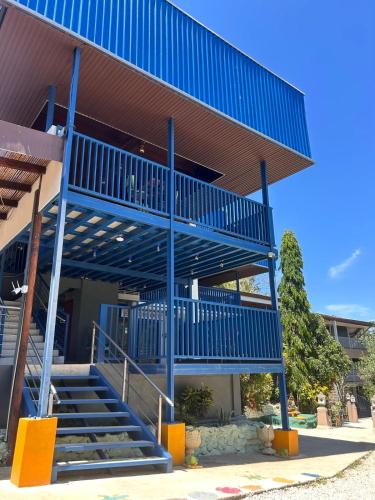 a blue staircase on the side of a building at Hotel Ticozuma in Montezuma