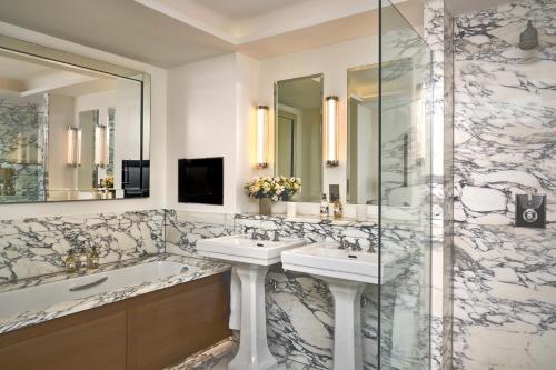 a bathroom with two sinks and a shower at The Soho Hotel, Firmdale Hotels in London