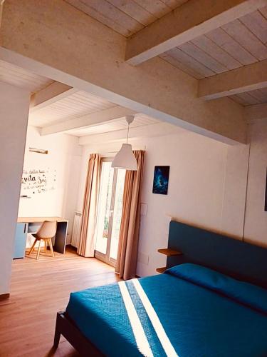 a bedroom with a blue bed in a room at Villa Celeste in Brusciano