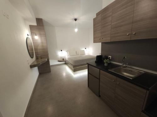 a kitchen with a sink and a bed in a room at Litmus in Fira