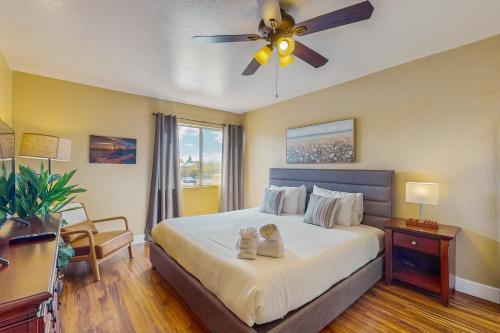 a bedroom with a bed with a ceiling fan at Camelback House in Scottsdale