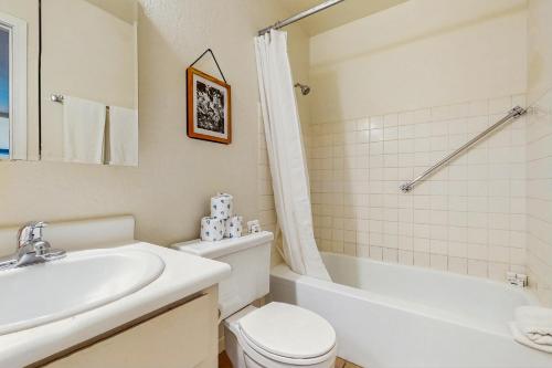 a bathroom with a sink and a toilet and a tub at Camelback House in Scottsdale