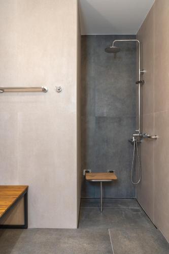a bathroom with a shower with a glass door at Dreta Suites in Chania Town