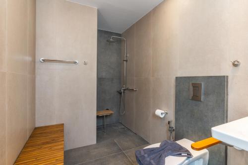 a bathroom with a shower with a toilet and a sink at Dreta Suites in Chania Town