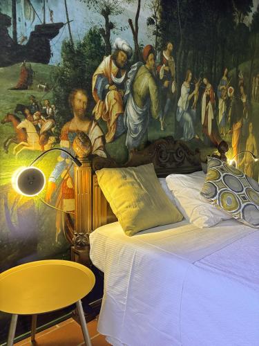 a bedroom with a painting on the wall and a bed at La Celeste Galeria in Mantova