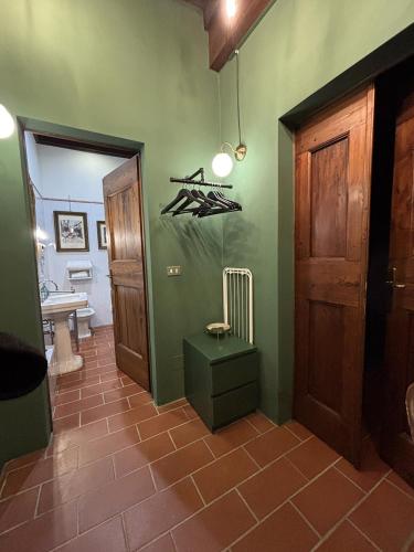 a bathroom with green walls and a bathroom with a toilet at La Celeste Galeria in Mantova