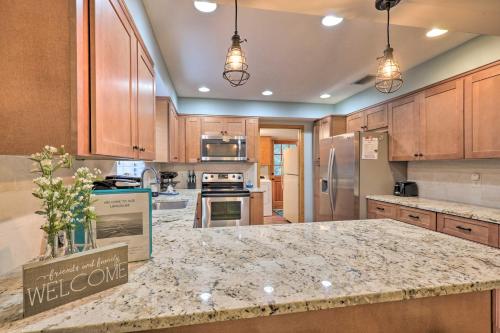 a kitchen with wooden cabinets and a granite counter top at 20 Mi to UF Campus Santa Fe Lake Escape with Dock! in Waldo