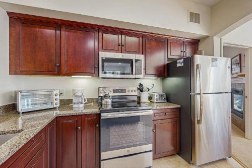 a kitchen with wooden cabinets and stainless steel appliances at Eagles Unit #2 in Jeffersonville