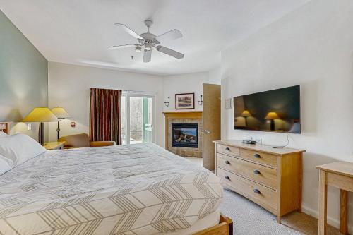a bedroom with a large bed and a fireplace at Eagles Unit #2 in Jeffersonville