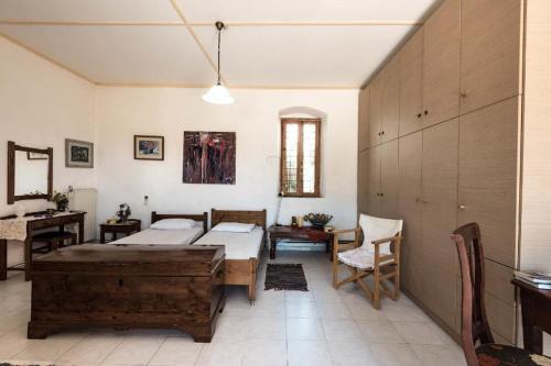 a bedroom with two beds and a table and a desk at Falasarna Lardas House in Falasarna