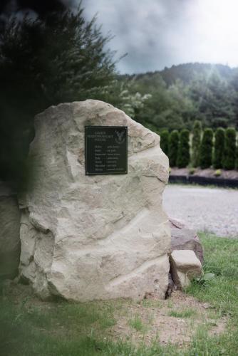 a rock with a sign on top of it at Jodłowa Chata in Myślenice