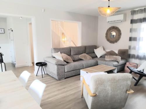 a living room with a couch and a table at House with 5 bedrooms and HOT TUB in Saint Cyprien Plage