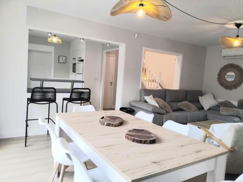 a living room with a table and a couch at House with 5 bedrooms and HOT TUB in Saint Cyprien Plage