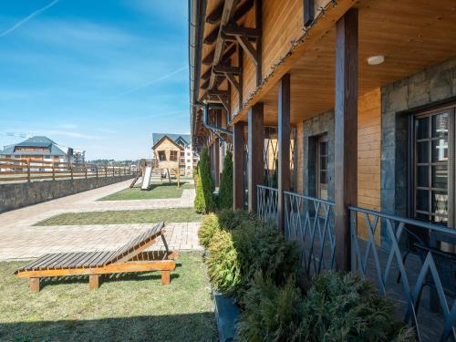 a wooden bench sitting outside of a building at The Zlatibor Chalet in Zlatibor