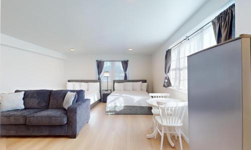 a living room with a couch and a bed at The Cape in Cape May