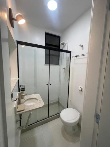 a bathroom with a toilet and a glass shower at Condo ipanema 209 in Rio de Janeiro