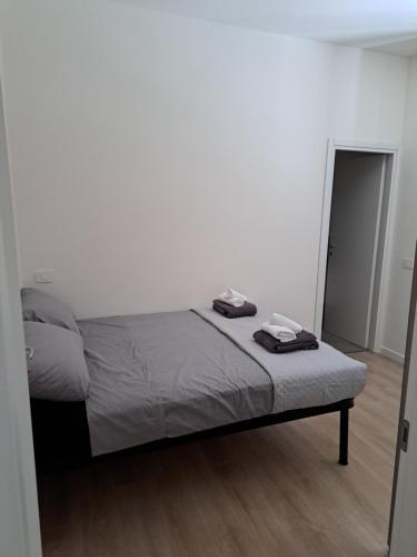 a bed in a white room with a mirror at San Francesco Home in Terni