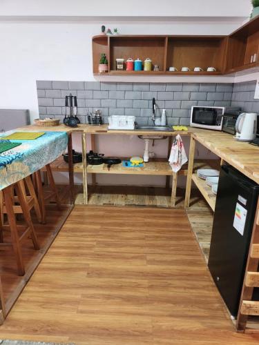 a kitchen with wooden tables and a counter top at Alojamiento San Francisco - Apartamentos y habitaciones in Lima