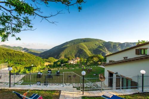 a view from a house with mountains in the background at Acquanera 6&2 by Marche Holiday Villas in Piobbico