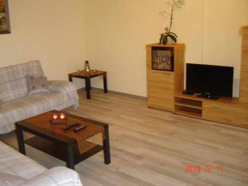 a living room with a couch and a tv at Santa Maria in Nettersheim